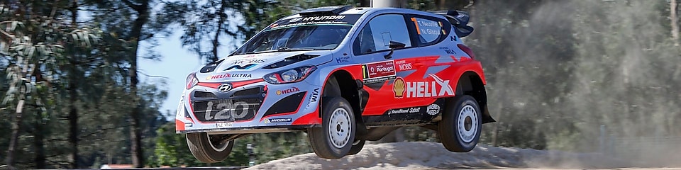 An Hyundai Shell World Rally Team car racing through a forest