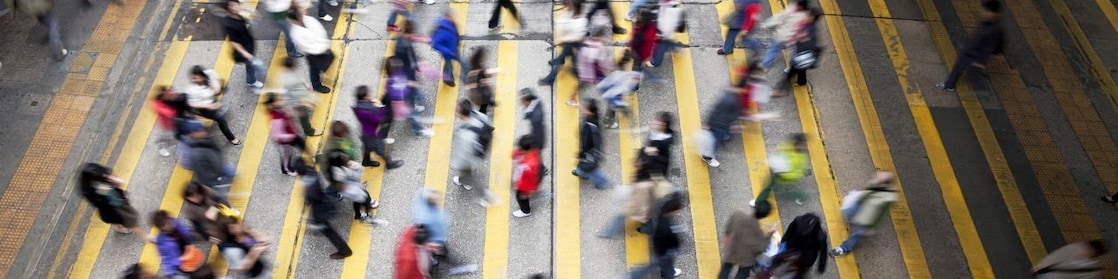 Personas cruzando una calle llena de gente en Hong Kong