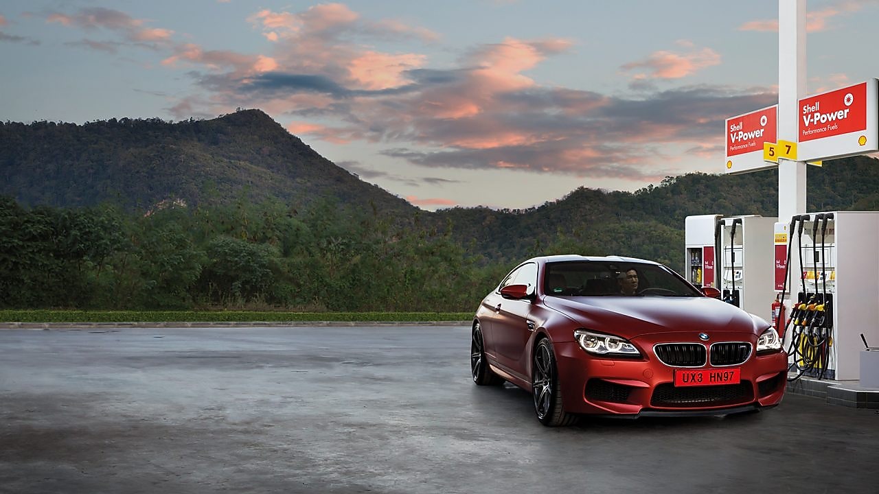 Red car in Shell forecourt