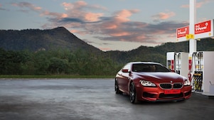 Red car in Shell forecourt