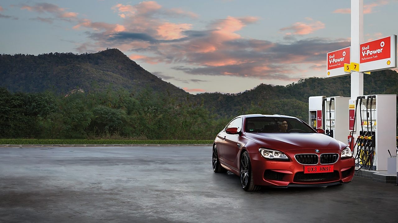 Red car in Shell forecourt