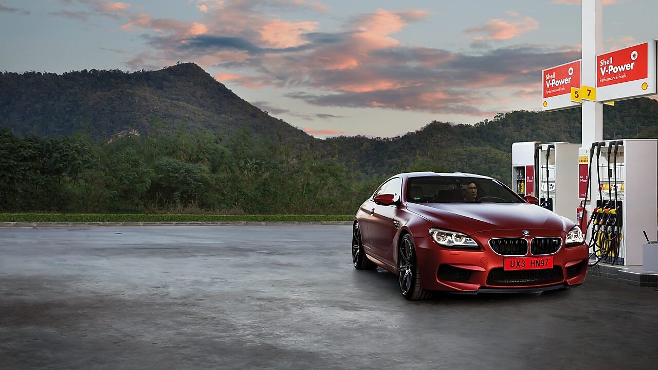 Red car in Shell forecourt