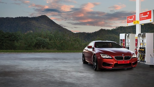 Red car in Shell forecourt