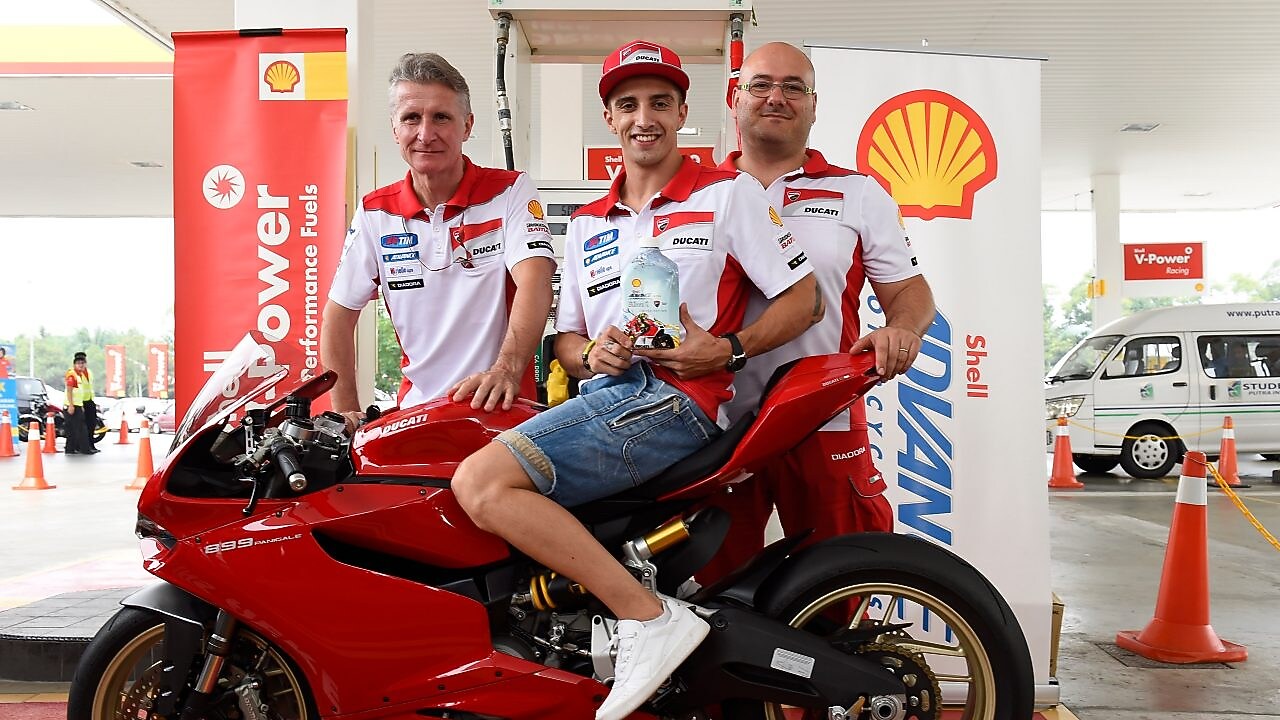 Ducati superbike with seated rider and tech team