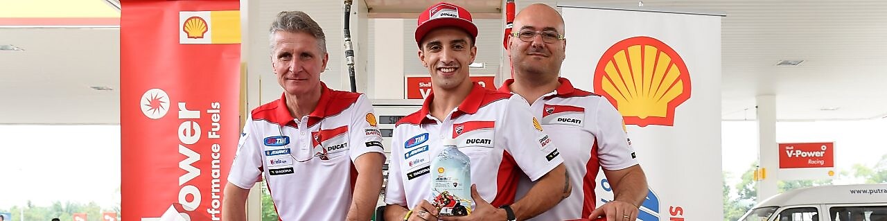 Ducati superbike with seated rider and tech team