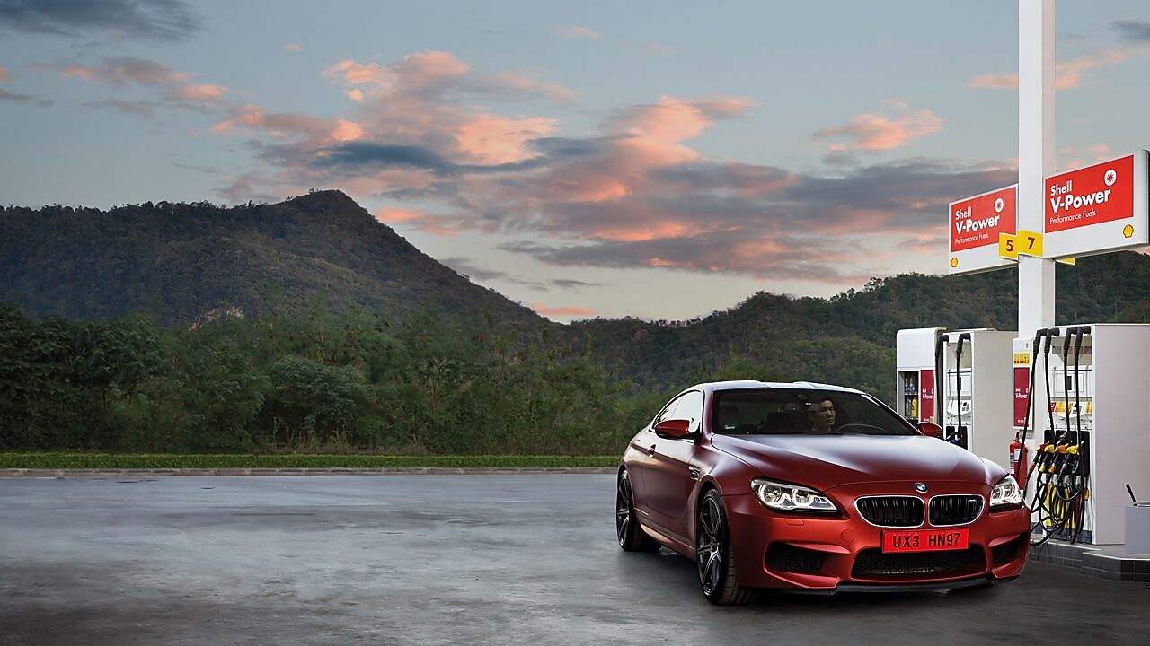Red car in Shell forecourt