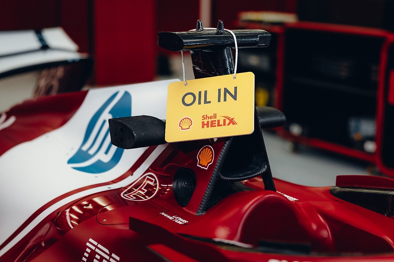 Ferrari F1 car racing on sunny track with palm trees