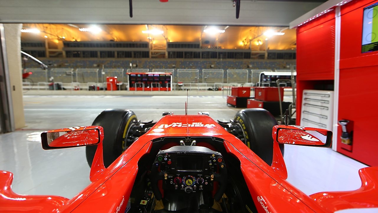 Ferrari dentro de un garaje cerca de una pista